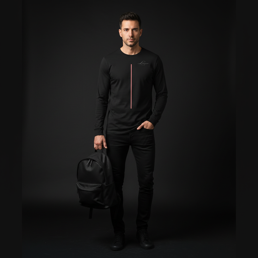 Man holding a black backpack against a dark background, wearing a black long sleeve tee