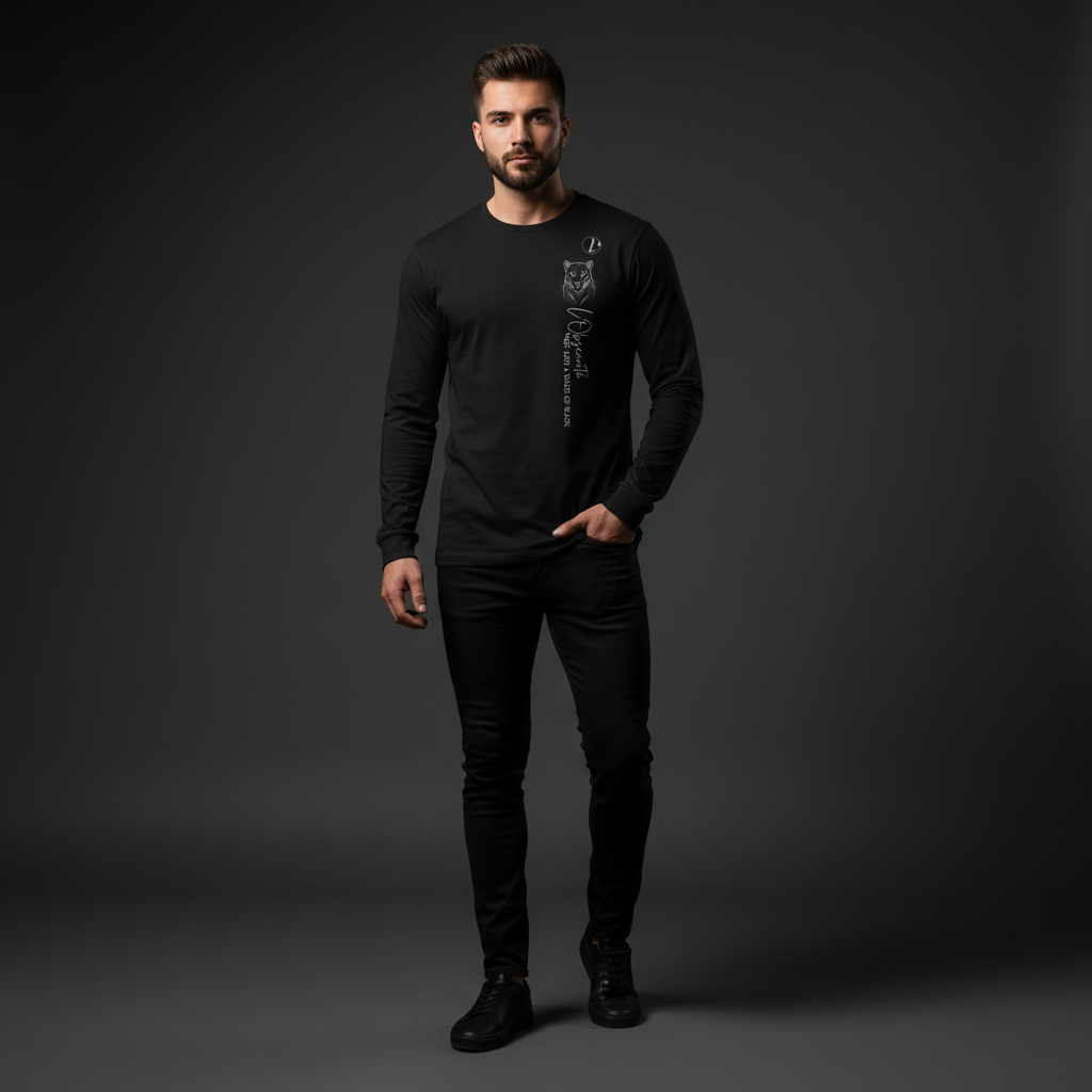 Man wearing a black long-sleeve shirt and pants on a dark background, the shade of black long sleeve tee