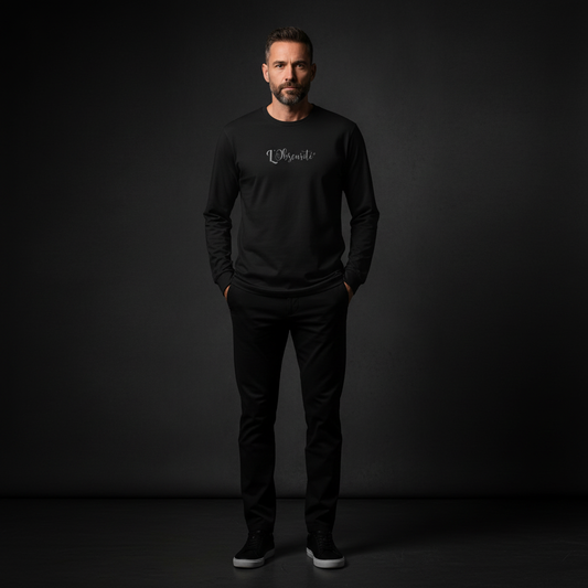 Man wearing a black long-sleeve shirt with a logo on a dark background, core long-sleeve tee