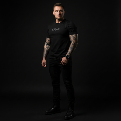 Man wearing a black t-shirt with visible branding against a dark background, core tee