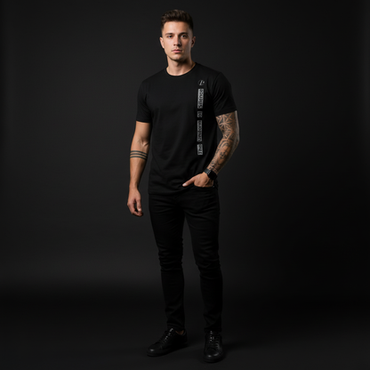 A man wearing a black t-shirt with a brand logo on a dark background, the uniform of silence