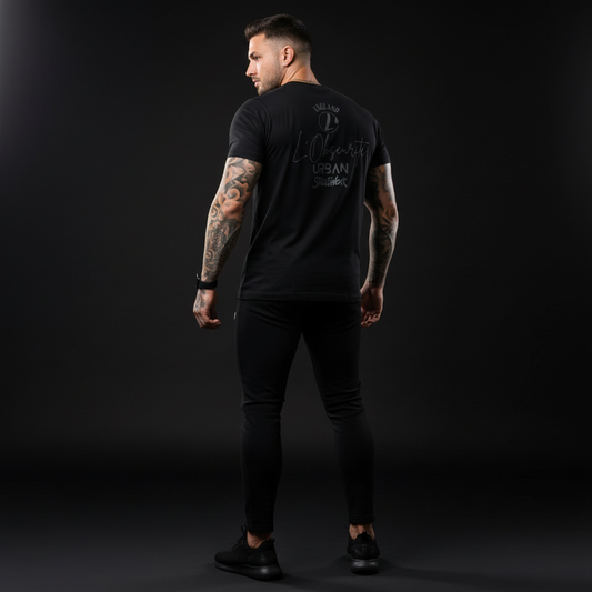 Man wearing a black V-neck t-shirt with text on the back against a dark background