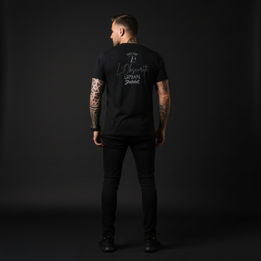 Person wearing a black t-shirt with text on the back against a dark background