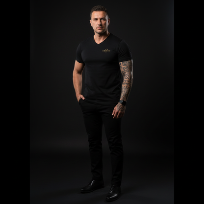Man wearing a black V-neck t-shirt with a Gold logo on a dark background