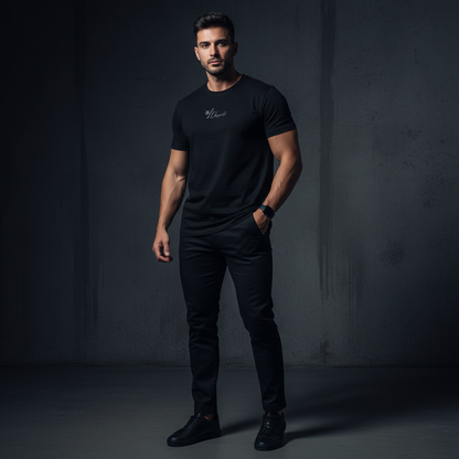 A man wearing a black t-shirt and pants against a dark background, serval t-shirt