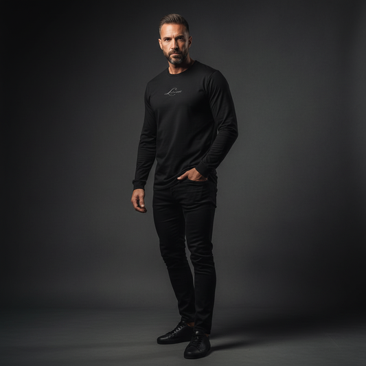 Man wearing a black long-sleeve shirt and pants against a dark background, the mark long sleeve tee