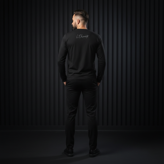 A man wearing a black long-sleeve shirt with a logo on the back against a dark background, classic and soft feel, 100% cotton